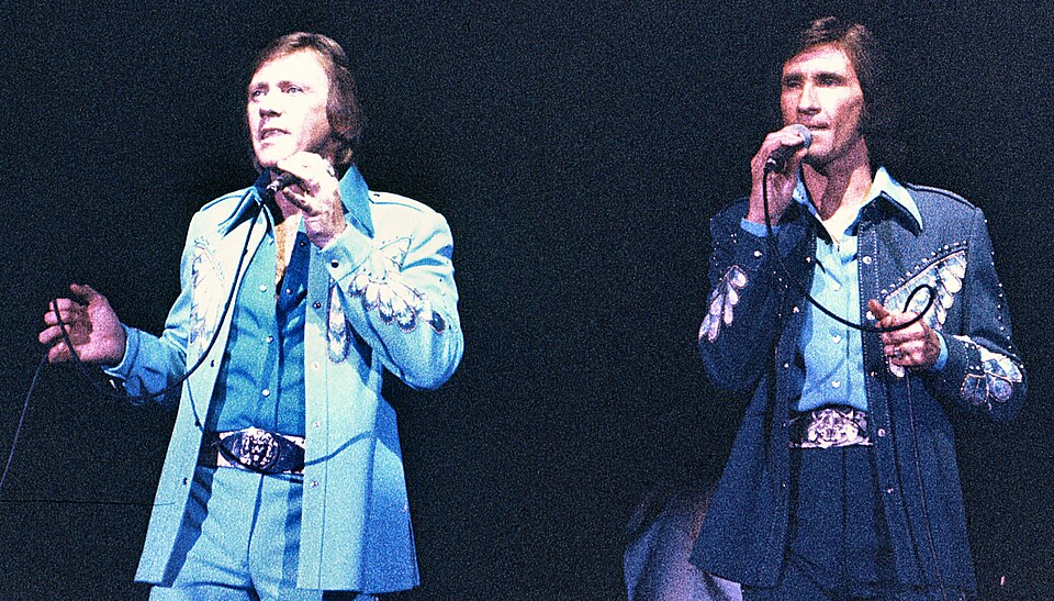 Bobby Hatfield and Bill Medley of the Righteous Brothers singing on stage in matching embroidered western suits