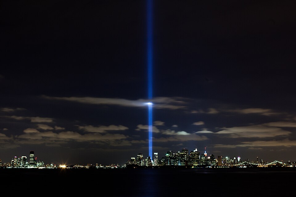 The Tribute in Light beams rising over the Lower Manhattan skyline at night